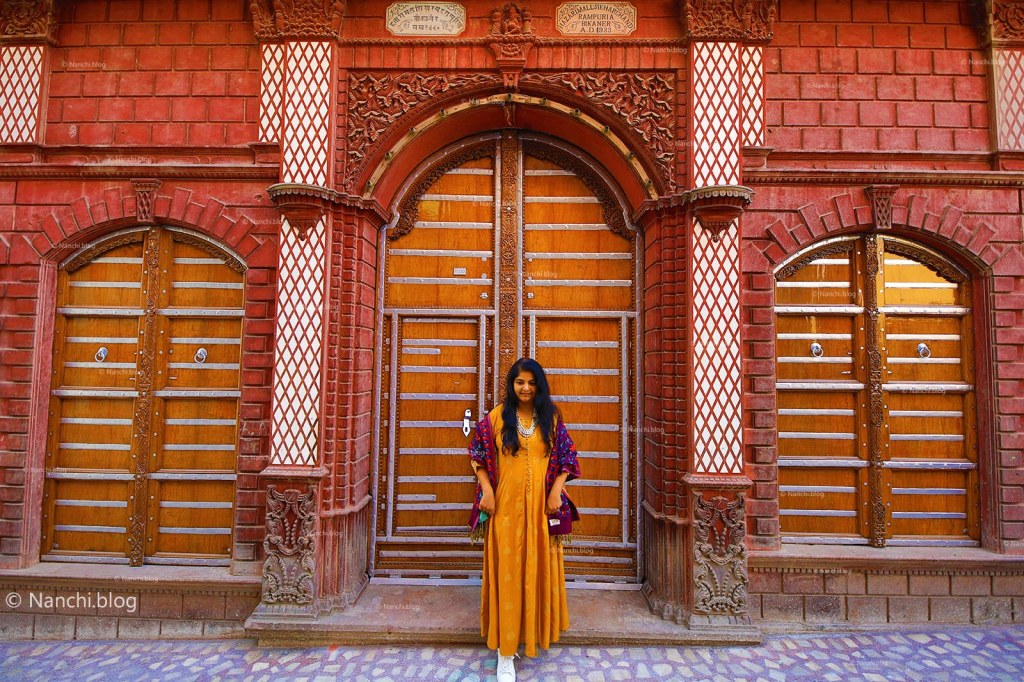 Nanchi in front of old doors at Rampuria Havelis, Bikaner, Rajasthan